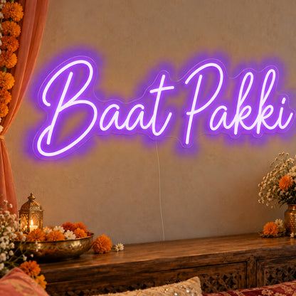 Baat Pakki Neon Sign in purple LED neon on clear acrylic, angled view