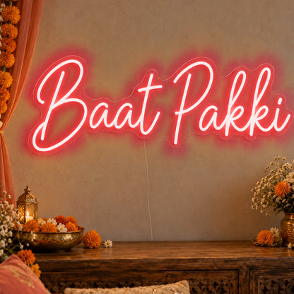Baat Pakki Neon Sign in red LED neon on clear acrylic, angled view