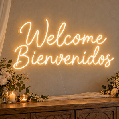 Welcome English & Spanish Neon Sign on clear cut-to-shape acrylic, illuminated on a wall in a styled celebration setting