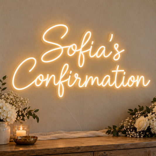 Personalised Confirmation Neon Sign on clear cut-to-shape acrylic, illuminated on a wall in a styled celebration setting; sample personalised wording shown