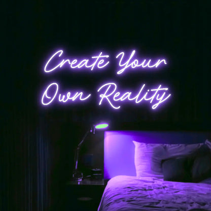 Create Your Own Reality LED Neon Light Sign in purple, featuring two lines of script lettering illuminated above a bed.