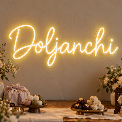 Doljanchi Neon Sign in gold LED neon on clear acrylic, angled view