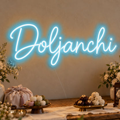 Doljanchi Neon Sign in ice blue LED neon on clear acrylic, angled view