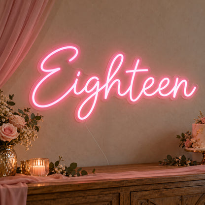 Eighteen Neon Sign on clear cut-to-shape acrylic, illuminated on a wall in a styled celebration setting