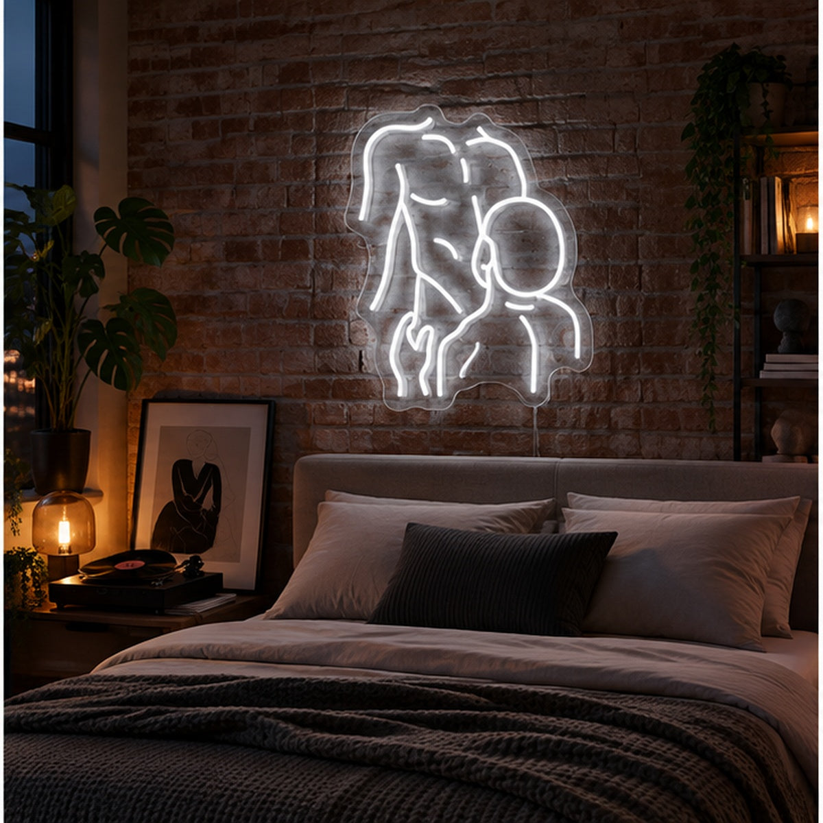 Gay Pride Two Men Neon Sign in white, featuring an outline of two men kissing on a brick bedroom wall above a bed.