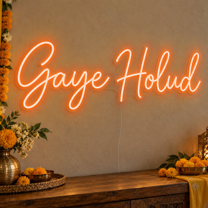 Gaye Holud Neon Sign in orange LED neon on clear acrylic, angled view