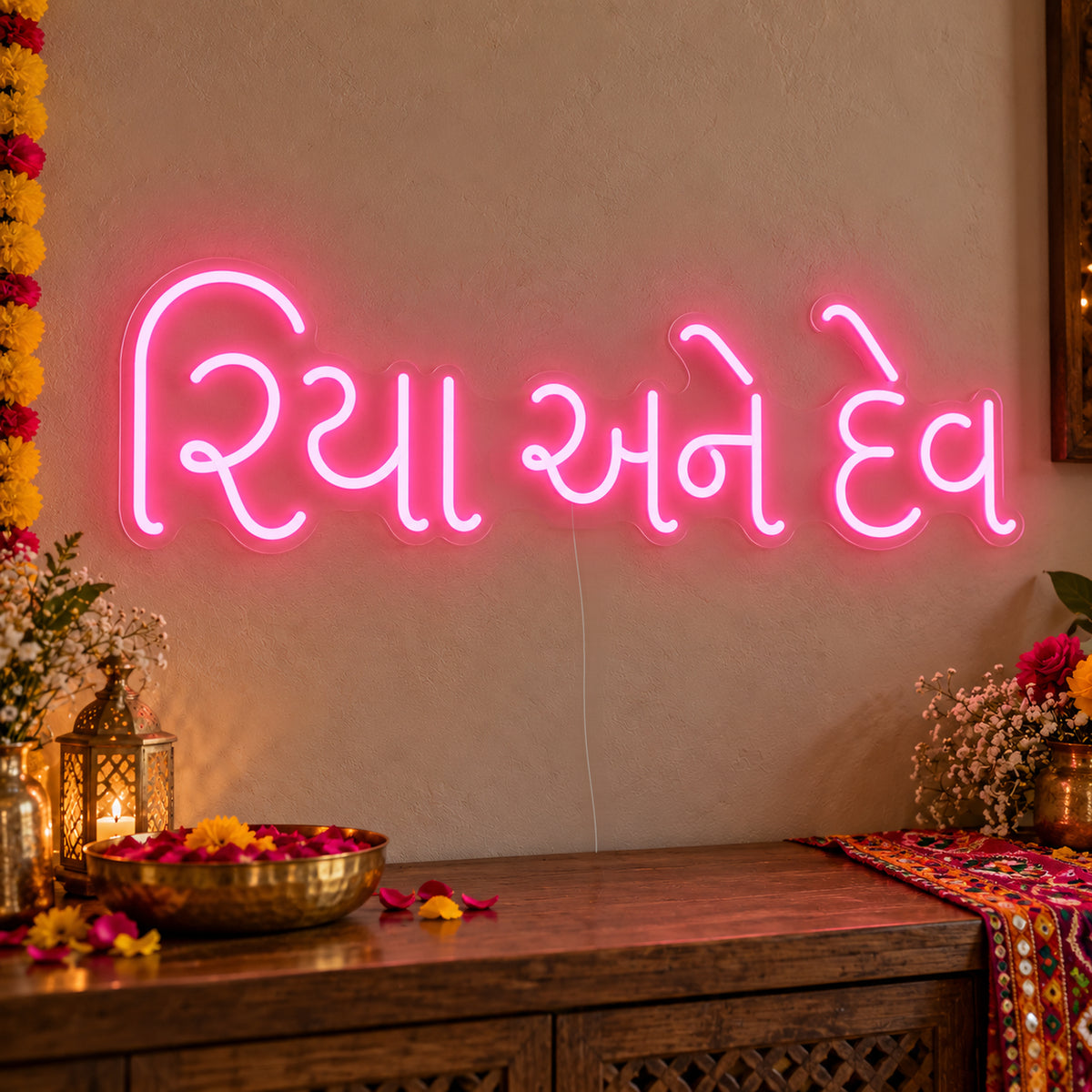 Personalised Gujarati Couple Names Neon Sign on clear cut-to-shape acrylic in an illuminated wall display; example personalisation shown.