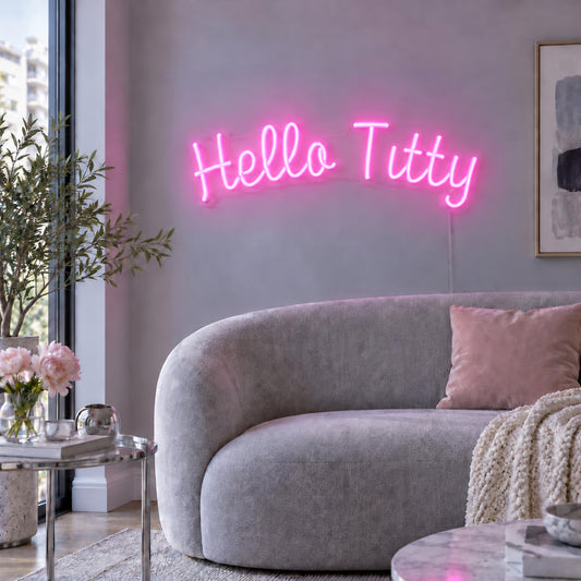 Hello Titty Neon Sign in pink, featuring Hello Titty script lettering above a pale curved sofa.