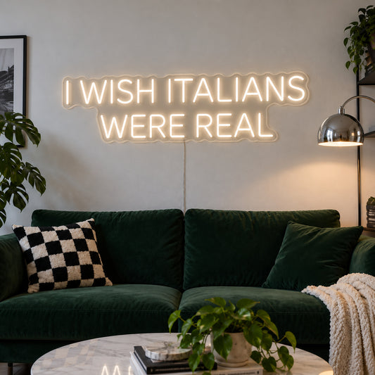 Warm White version of the I Wish Italians Were Real Neon Sign, shown above a green sofa.