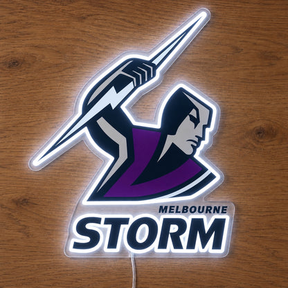 Melbourne Storm Neon Sign, featuring illuminated team logo on a wooden surface.