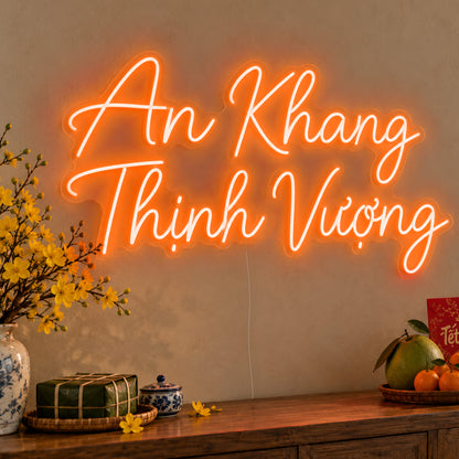 An Khang Thịnh Vượng Neon Sign in orange LED neon on clear acrylic, angled view