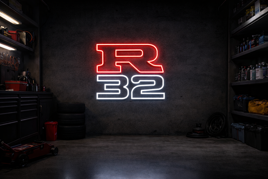 Nissan R32 LED neon sign with red R and white 32 outline mounted on concrete garage wall