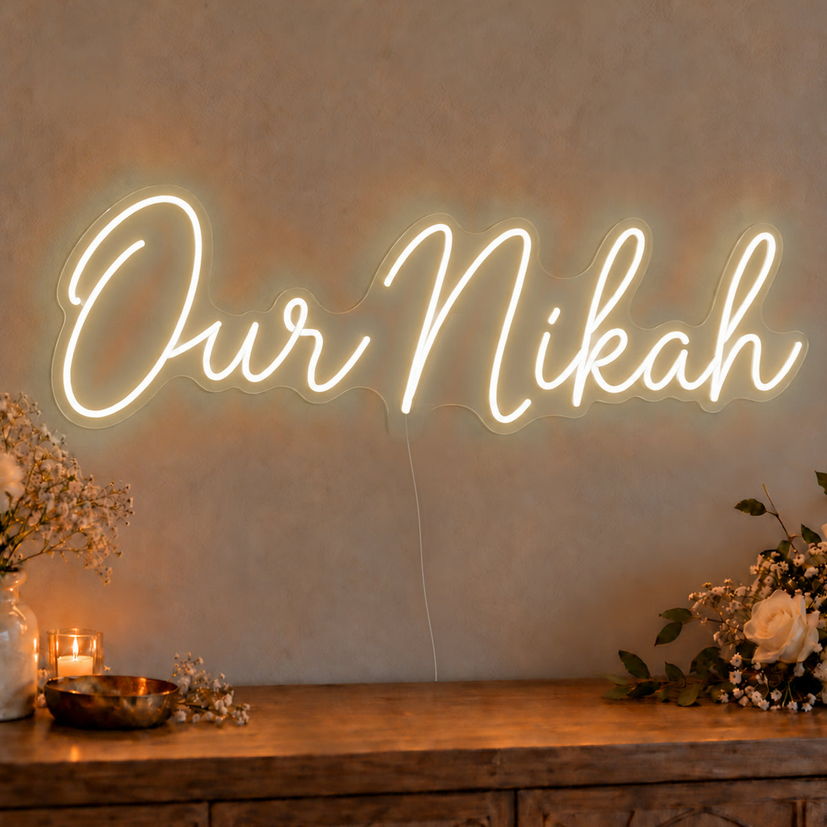 Our Nikah Neon Sign in warm white LED neon on clear acrylic, angled view