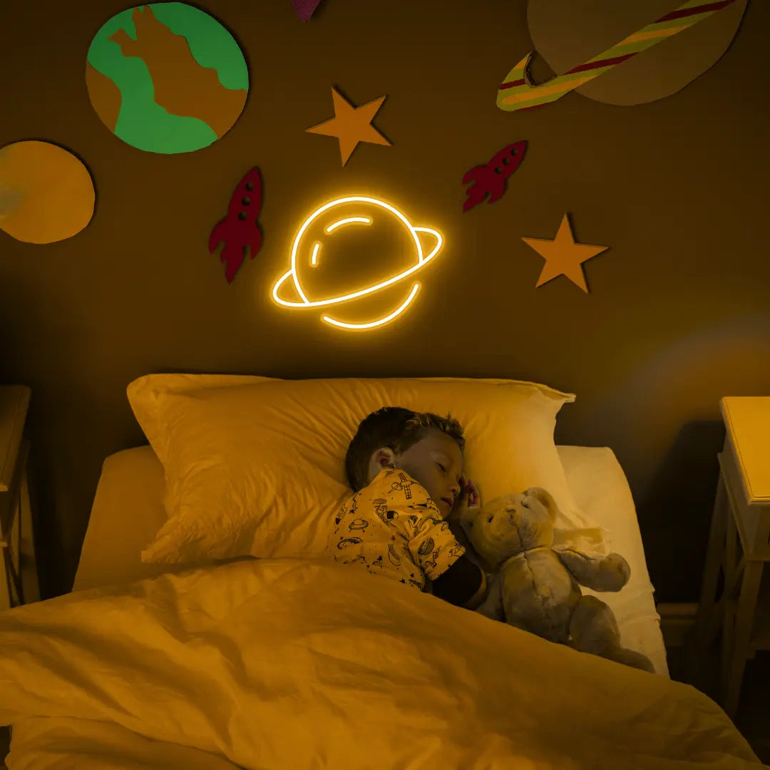 Planet LED Neon Light Sign in yellow, featuring ringed planet outline illuminated on a space-themed bedroom wall.