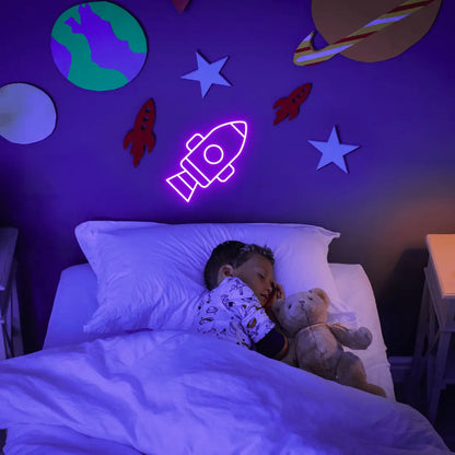 Rocket LED Neon Light Sign in purple, featuring rocket outline illuminated on a space-themed bedroom wall.