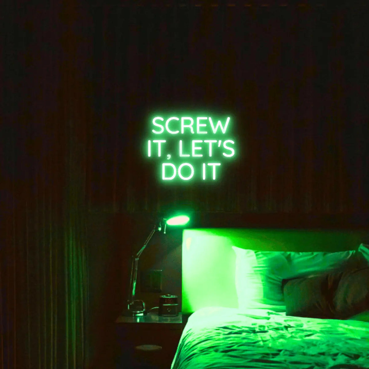 Screw It, Let's Do It LED Neon Light Sign in green, featuring stacked block lettering illuminated above a bed.
