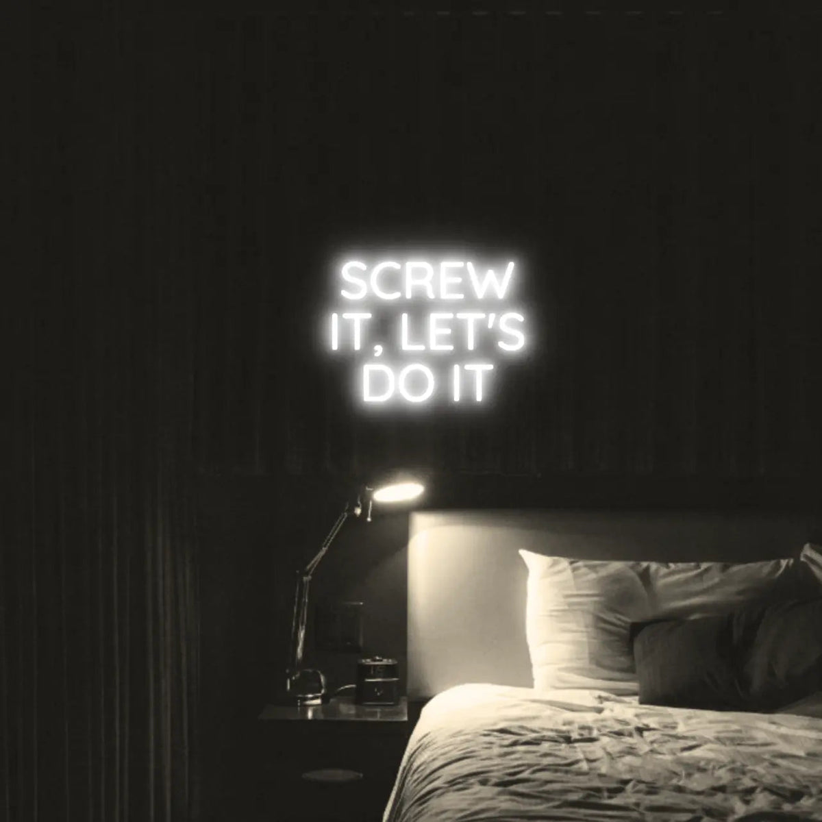Screw It, Let's Do It LED Neon Light Sign in white, featuring stacked block lettering illuminated above a bed.