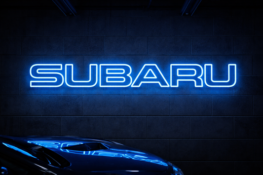 Subaru dark blue LED neon sign mounted on a garage wall above a blue car, glowing in bold blue light – automotive garage décor Australia.