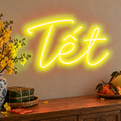 Tết Neon Sign in yellow LED neon on clear acrylic, angled view