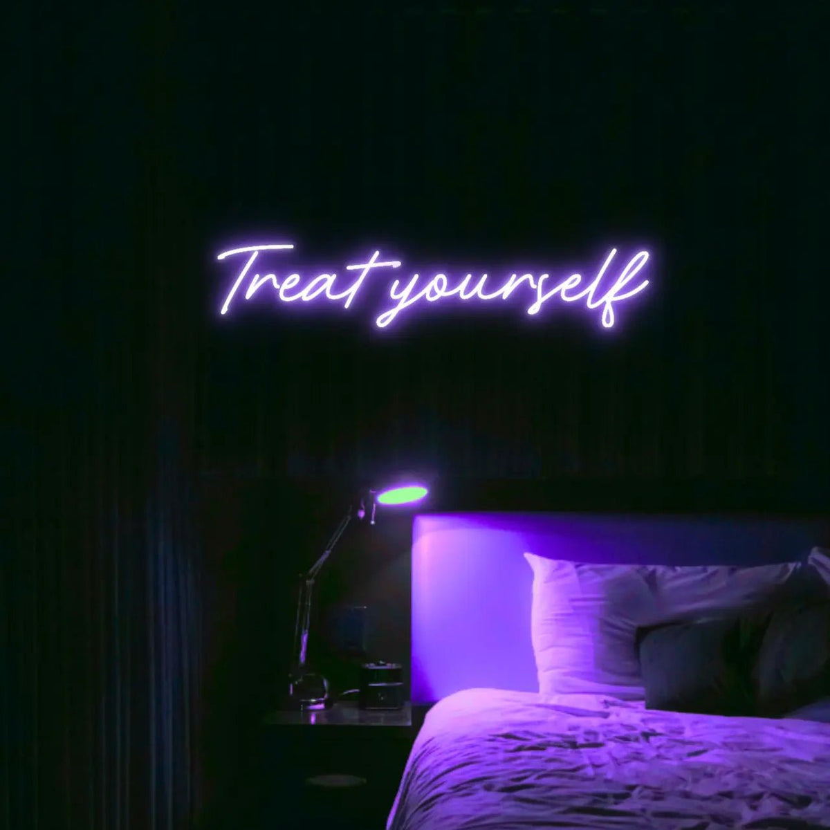 Treat Yourself LED Neon Light Sign in purple, featuring script lettering illuminated above a bed in a dark bedroom.