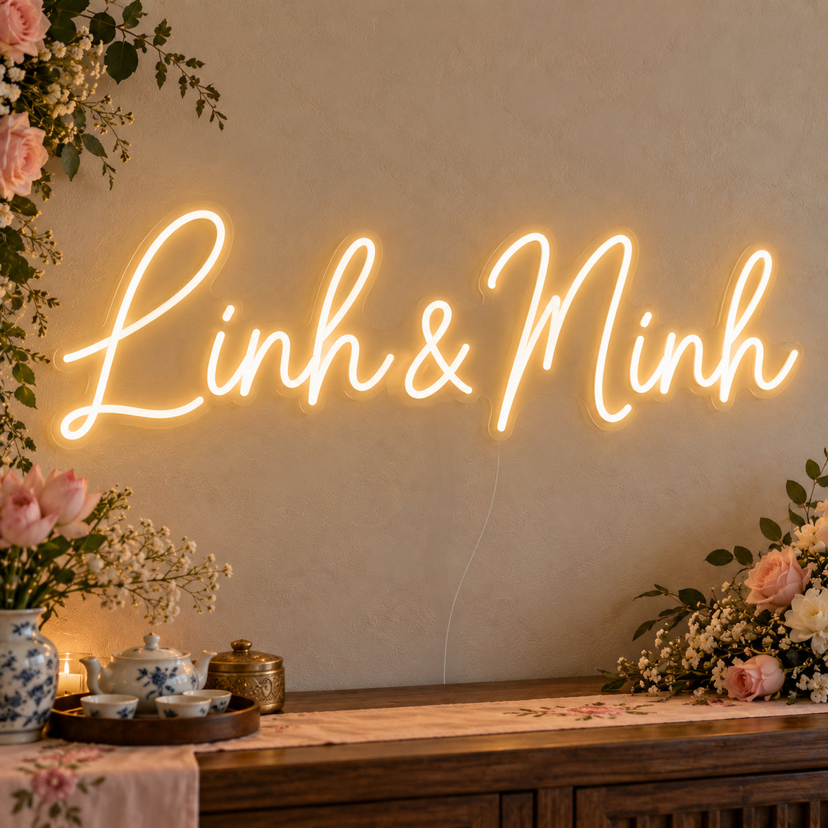 Personalised Vietnamese Couple Names Neon Sign on clear cut-to-shape acrylic in an illuminated wall display; example personalisation shown.